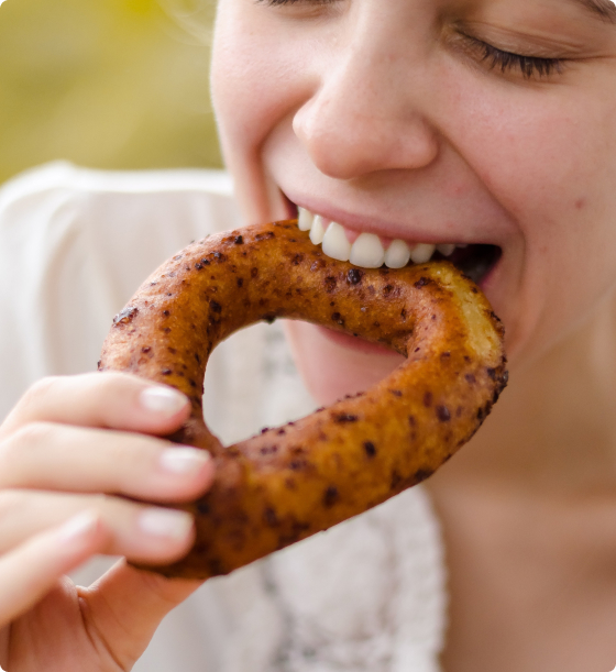 Woman eating a heart shaped pretzel